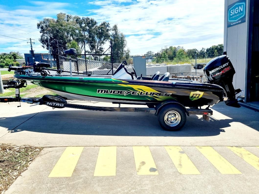 A Green and Black Fishing Boat is Parked in a Parking Lot — Robinsons Sign Makers In Shepparton, VIC