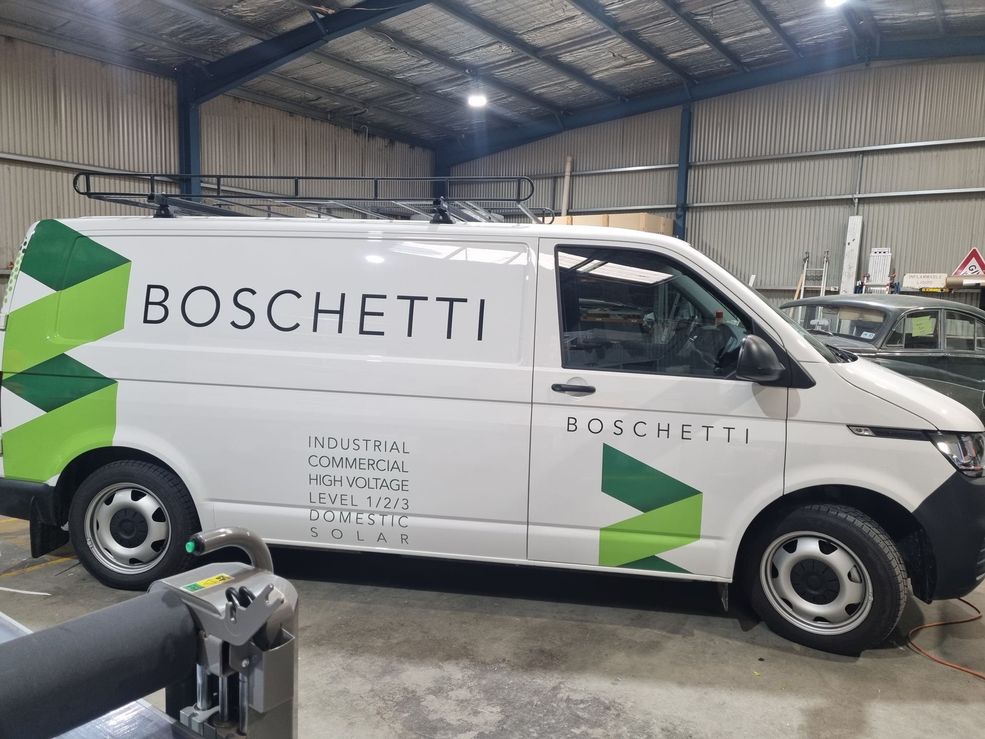 A White Van With the Word Boschetti on the Side is Parked in a Garage — Robinsons Sign Makers in Lavington, NSW