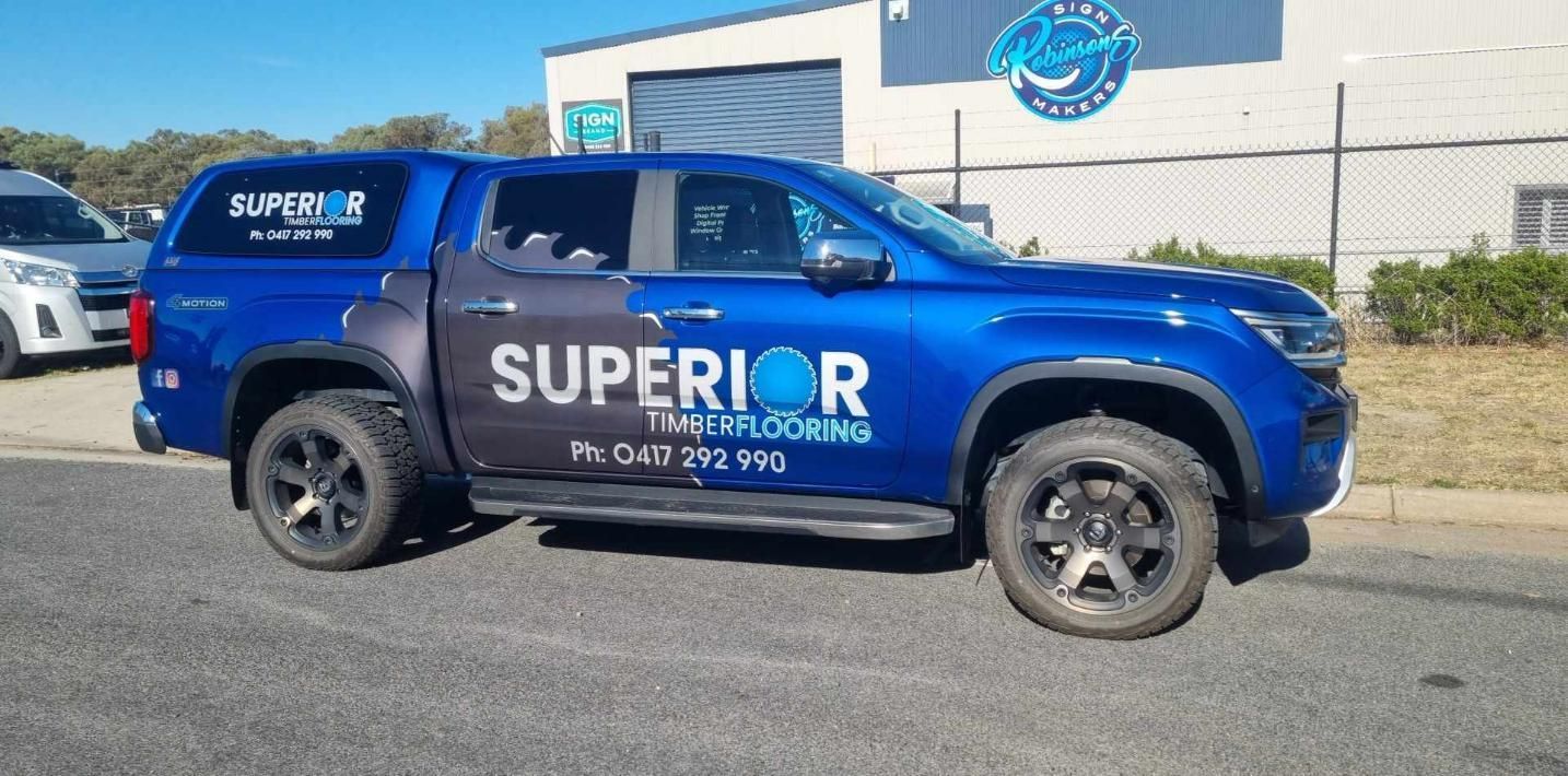 A Blue and Black Van is Parked in a Parking Lot — Robinsons Sign Makers in Lavington, NSW