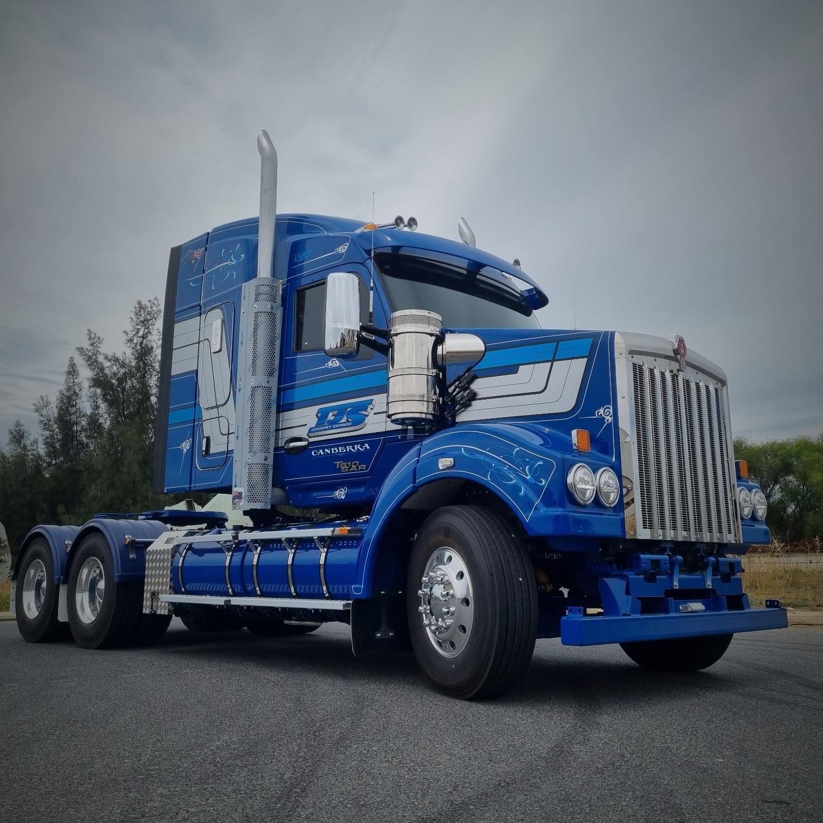 A Blue Semi Truck is Parked on the Side of the Road — Robinsons Sign Makers in Canberra, ACT
