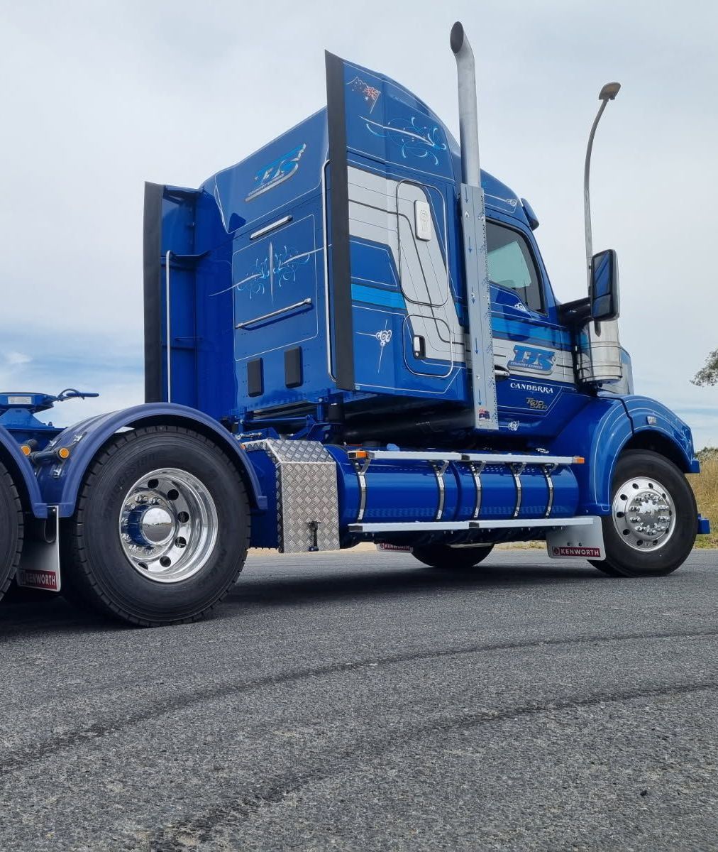 A White Truck With a Green Canopy is Parked on the Side of the Road — Robinsons Sign Makers in Canberra, ACT