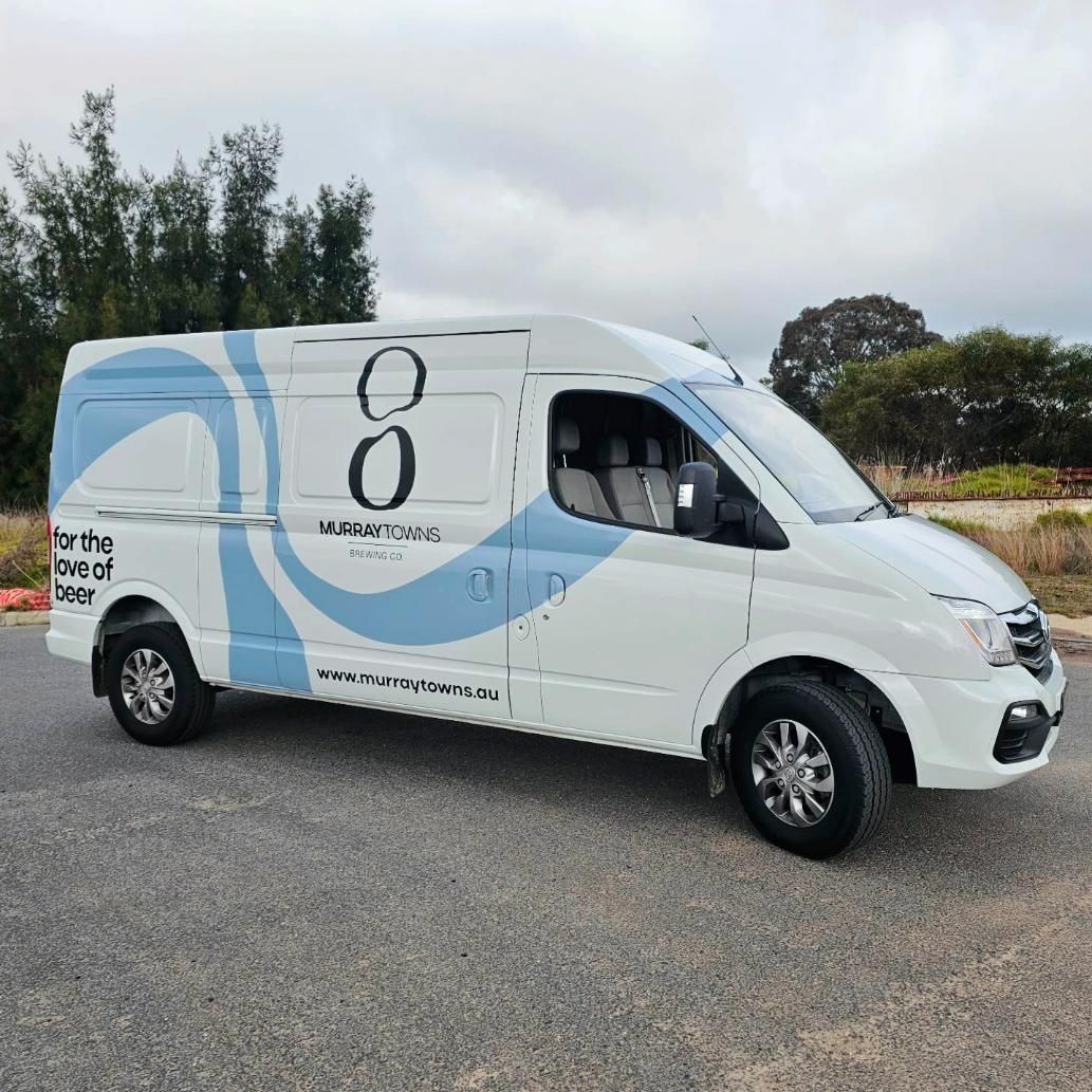 A White Van With the Number 8 on the Side is Parked on the Side of the Road — Robinsons Sign Makers In Shepparton, VIC