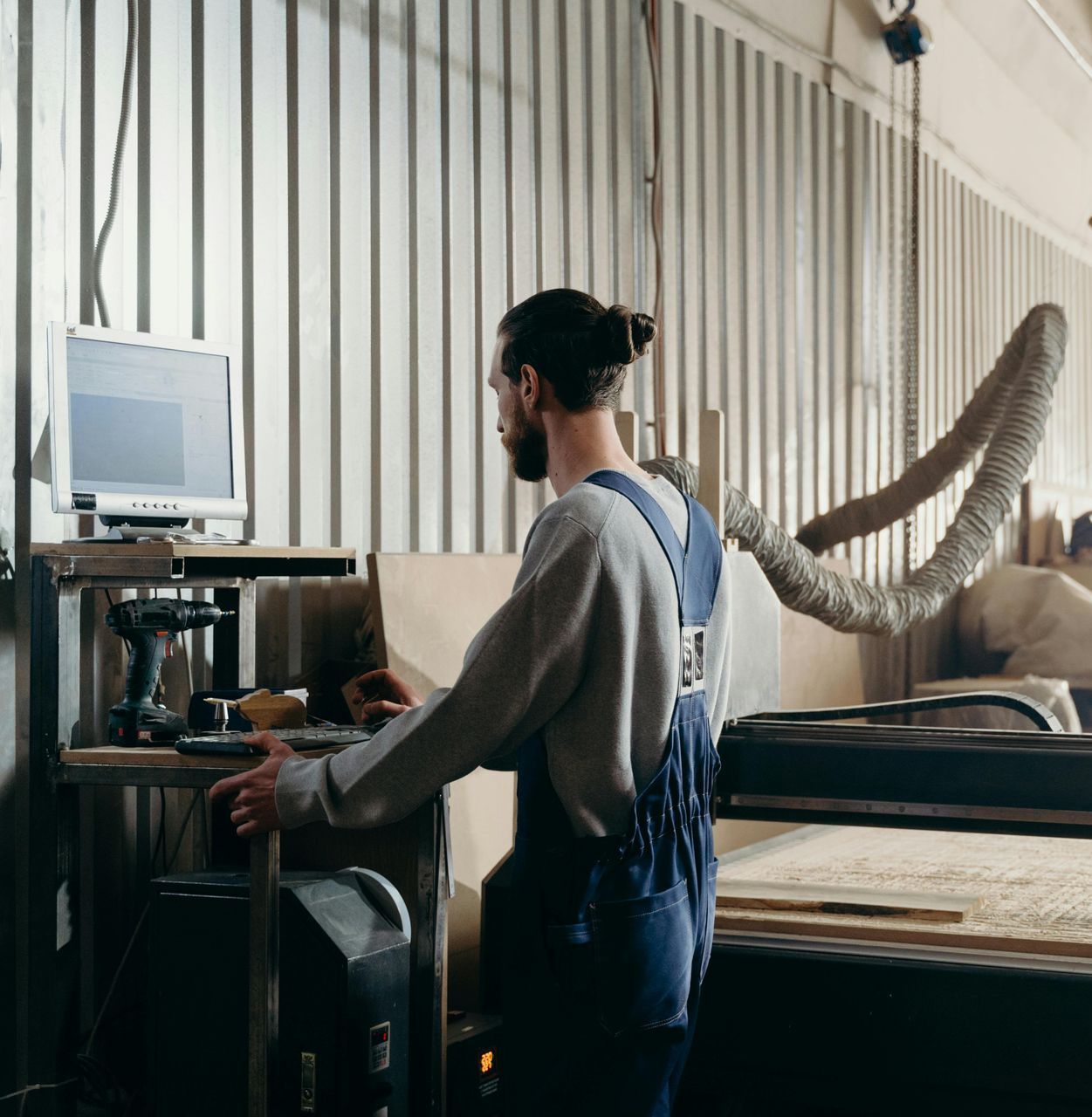 A man is working on a machine in a factory.
