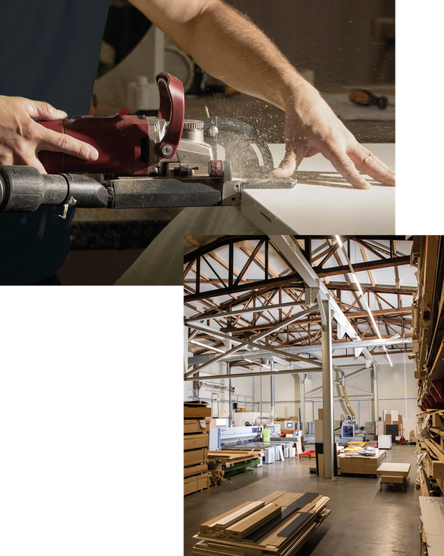 A man is working on a piece of wood in a warehouse.