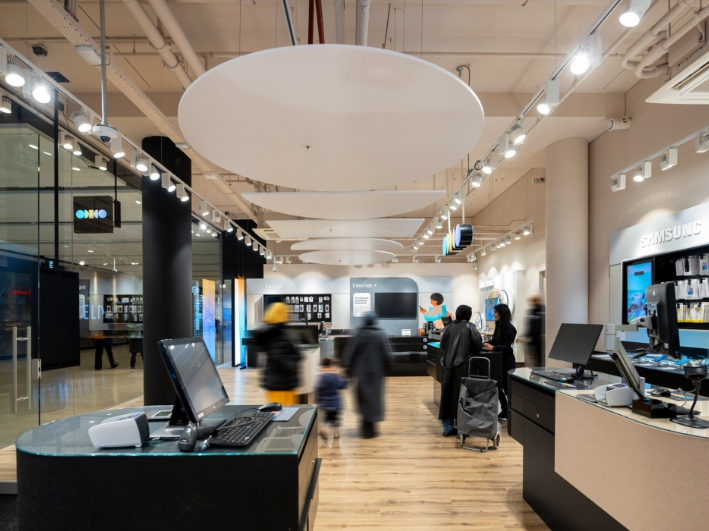 A group of people are standing in a store.