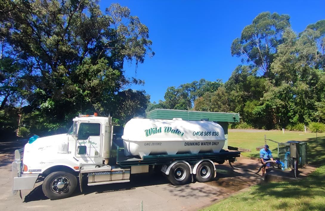 A White Truck is Parked in a Parking Lot With Trees in the Background — Wild Water Delivery in Mooloolah, QLD