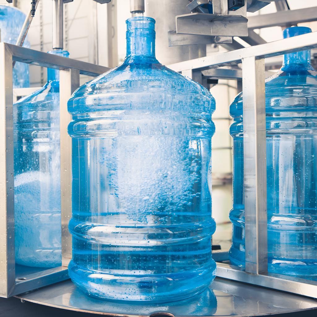A Large Bottle of Water is Sitting on Top of a Machine — Wild Water Delivery in Peachester, QLD