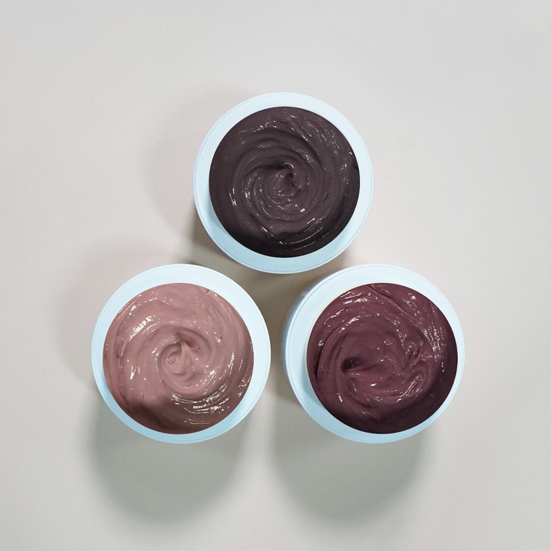 Three Bowls of Different Colored Cream Are Sitting on a Table — Innovative Hair Salon in Gosford, NSW