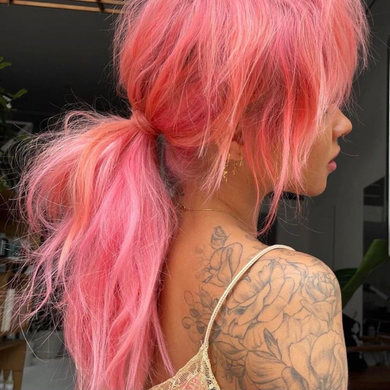 A Woman With Pink Hair Has a Tattoo on Her Back — Innovative Hair Salon in Gosford, NSW