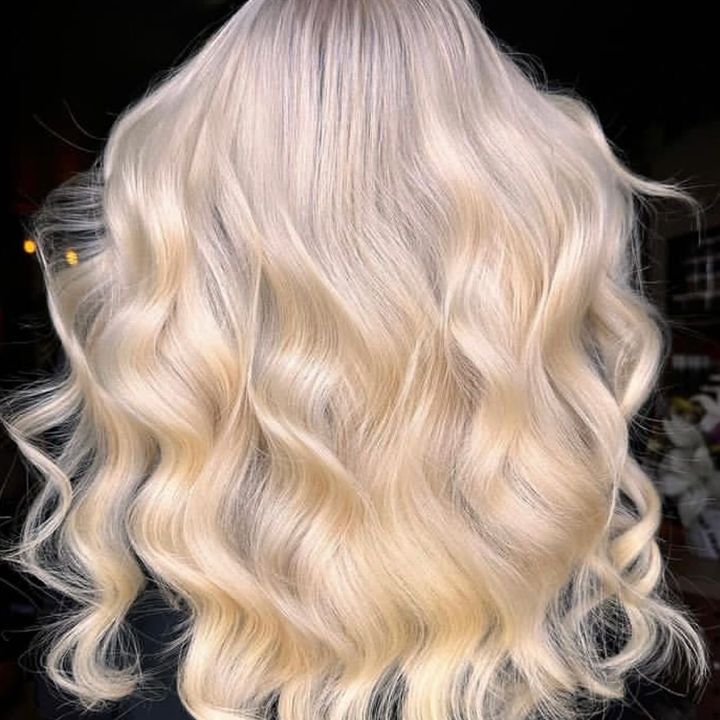 A Woman With Long Brown Hair is Wearing a Sweater — Innovative Hair Salon in Gosford, NSW