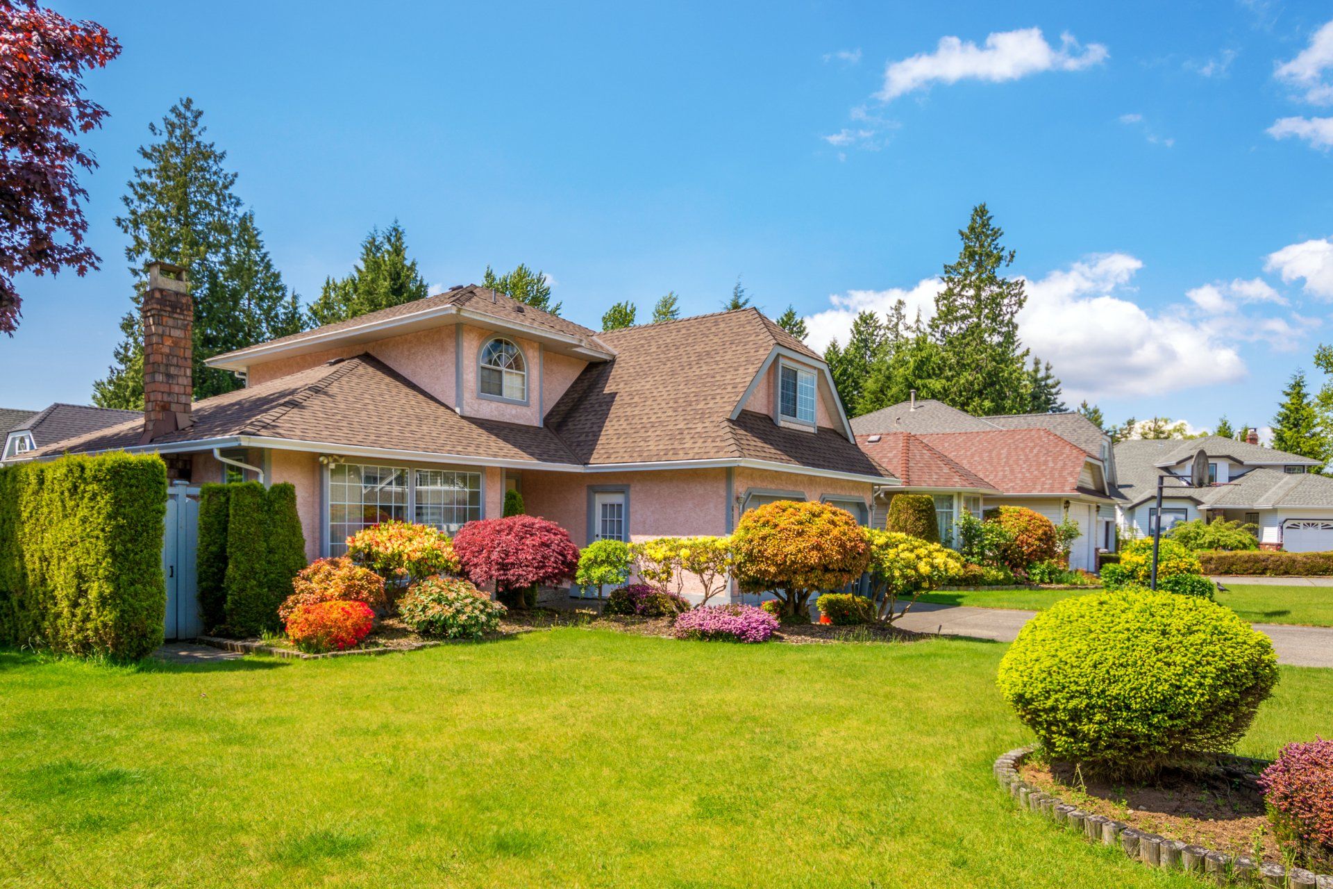 Luxury house with beautiful landscaping on a sunny day