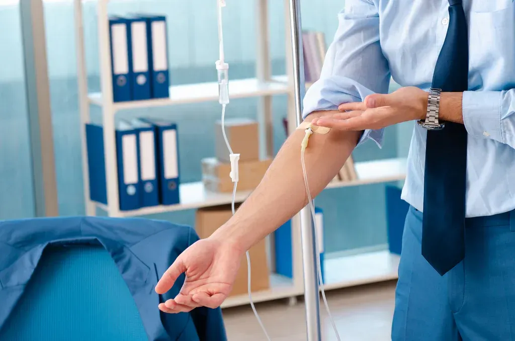 Healthcare worker taking a patient’s blood pressure in a clinic room