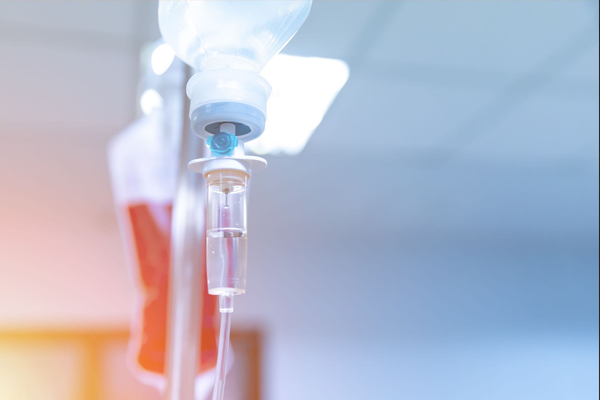 Close-up of an IV drip with clear fluid in a hospital setting