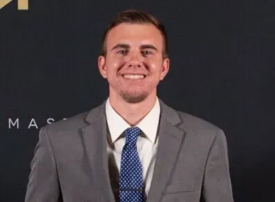 A man in a suit and tie is smiling for the camera.