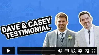 Two men in suits and ties are standing next to each other on a blue background.