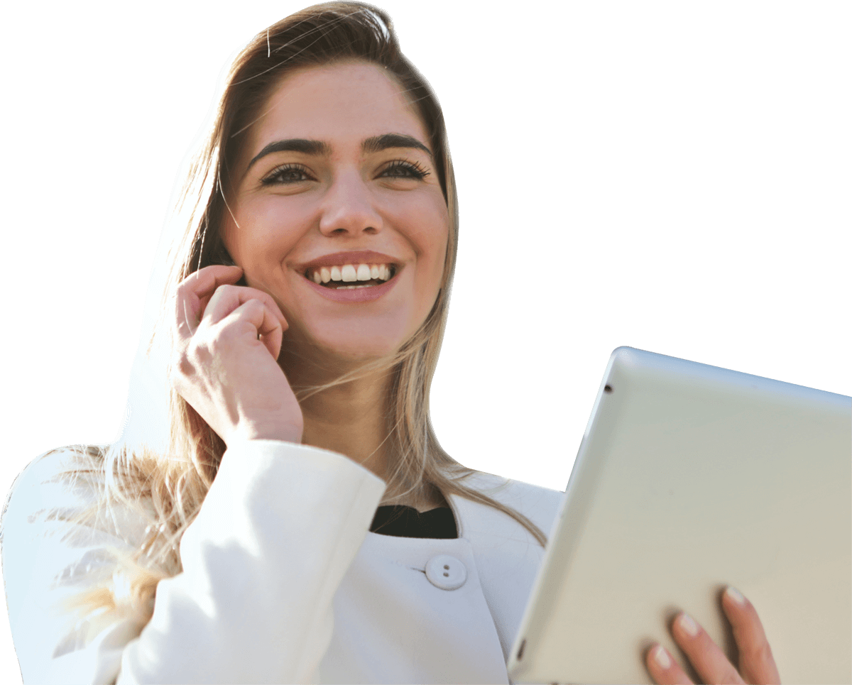 A woman is holding a tablet and talking on a cell phone. Woman in white blazer smiles while holding a tablet and phone.