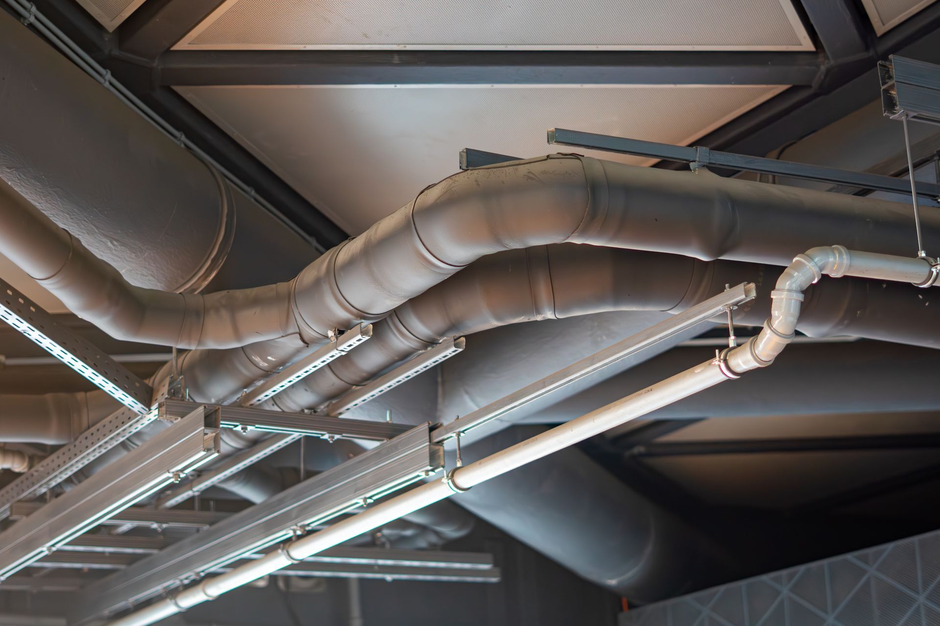 A builder is making and installing a wall fan vent. A builder is making and installing a wall fan vent.