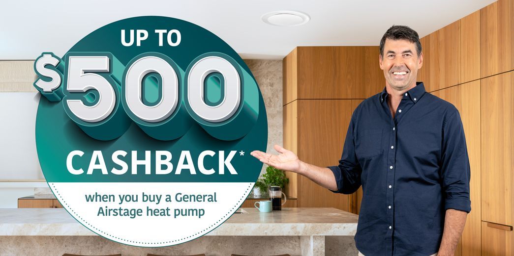 Man in navy shirt presenting a sign that says “Up to $500 Cashback” in a modern kitchen Man in navy shirt presenting a sign that says “Up to $500 Cashback” in a modern kitchen