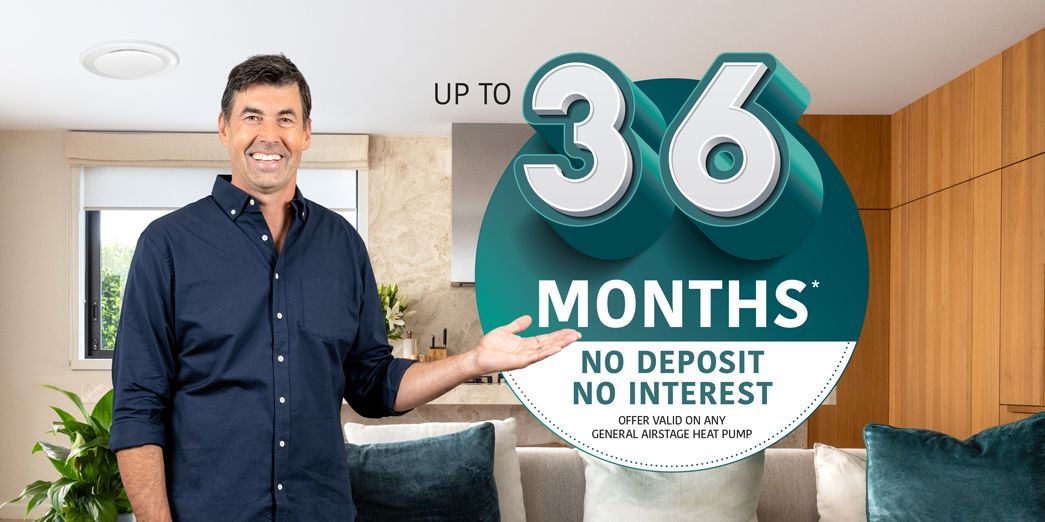 Man standing beside a teal sign reading “36 months” and “No deposit, no interest” in a bright room Man standing beside a teal sign reading “36 months” and “No deposit, no interest” in a bright room