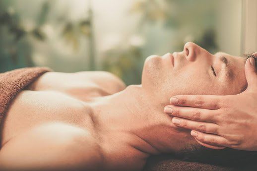 Man receiving a face massage in a spa.