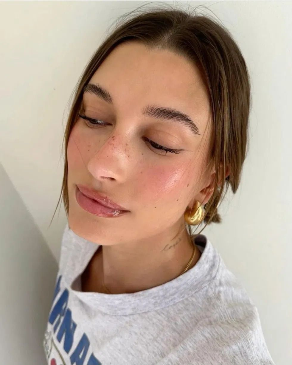 Soft low natural eyebrow arch following the brow bone