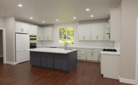 3D kitchen design visualization showing white shaker cabinets, dark navy island with quartz countertop, hardwood floors, and white tile backsplash for a Sacramento kitchen remodel