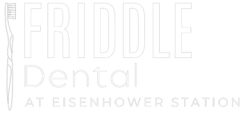 White Friddle Dental logo with stylized tooth and “At Eisenhower Station” text