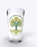 Clear pint glass with green Celtic shamrock-style design and curved text logo.