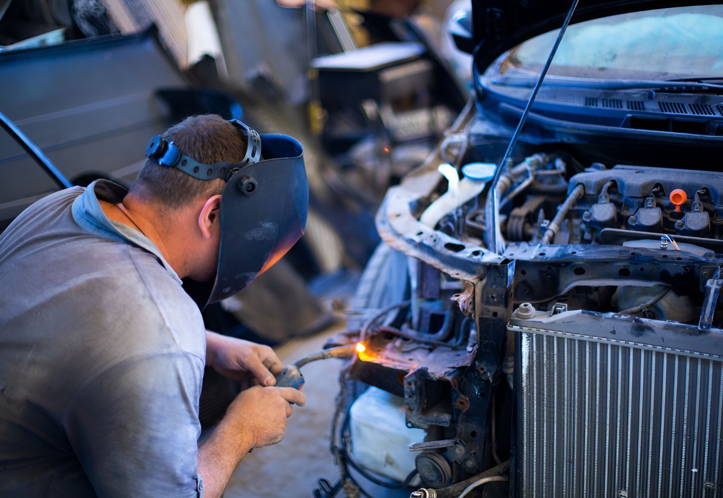 A Man Wearing A Welding Mask — All Models Service Centre In Laurieton, NSW