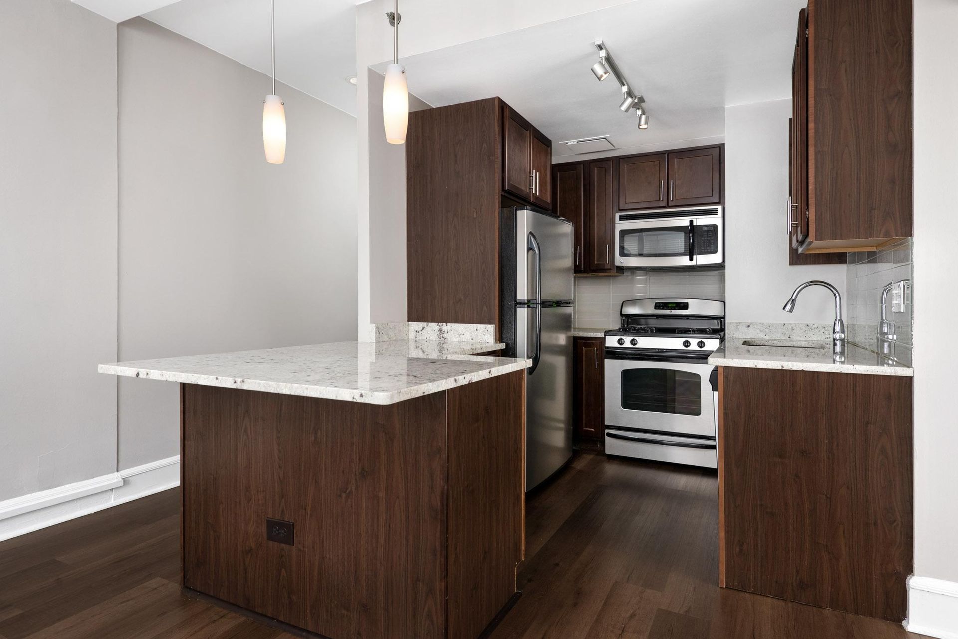 a kitchen with wooden cabinets and stainless steel appliances