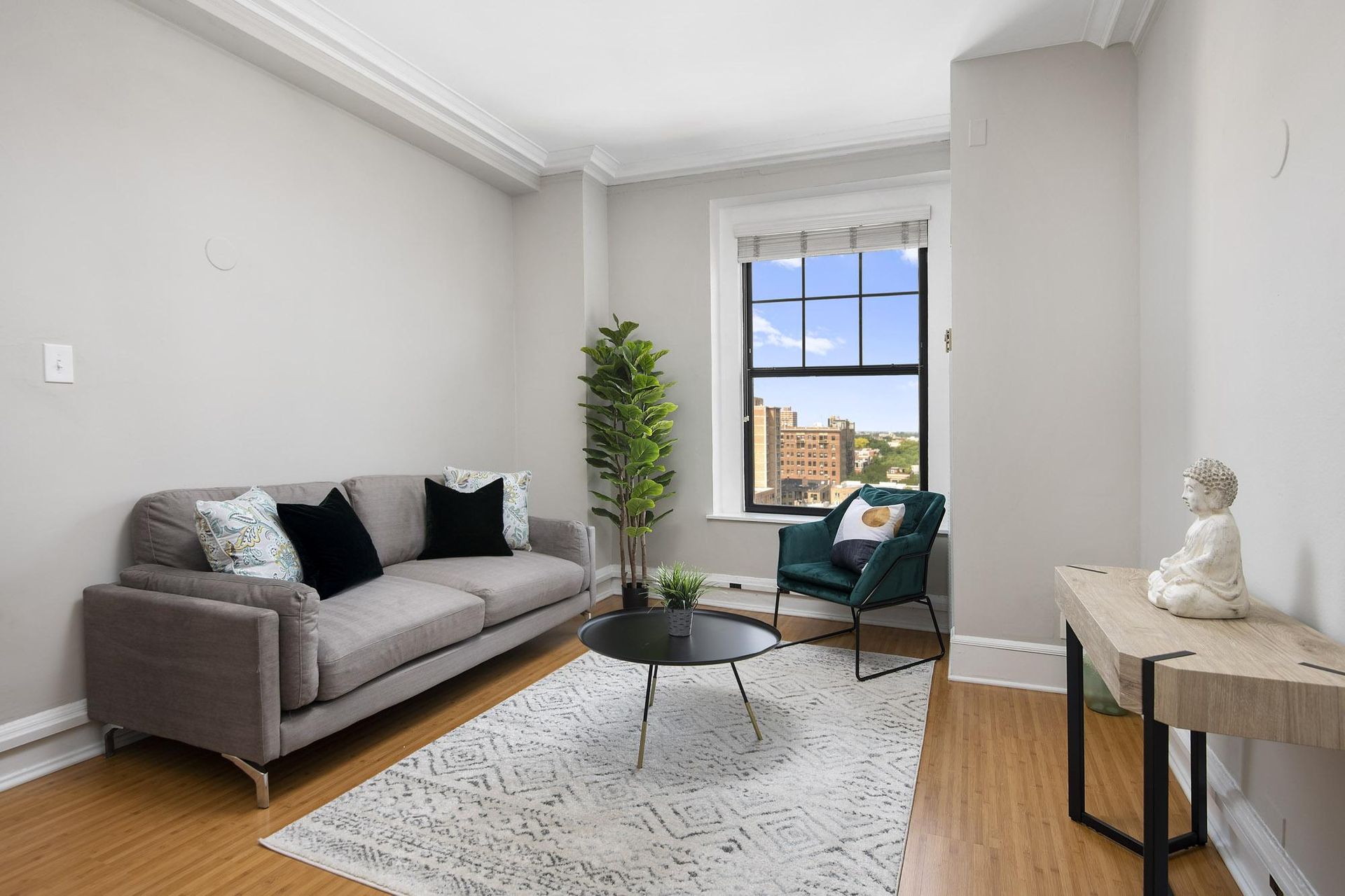 a living room with a couch and a chair and a window