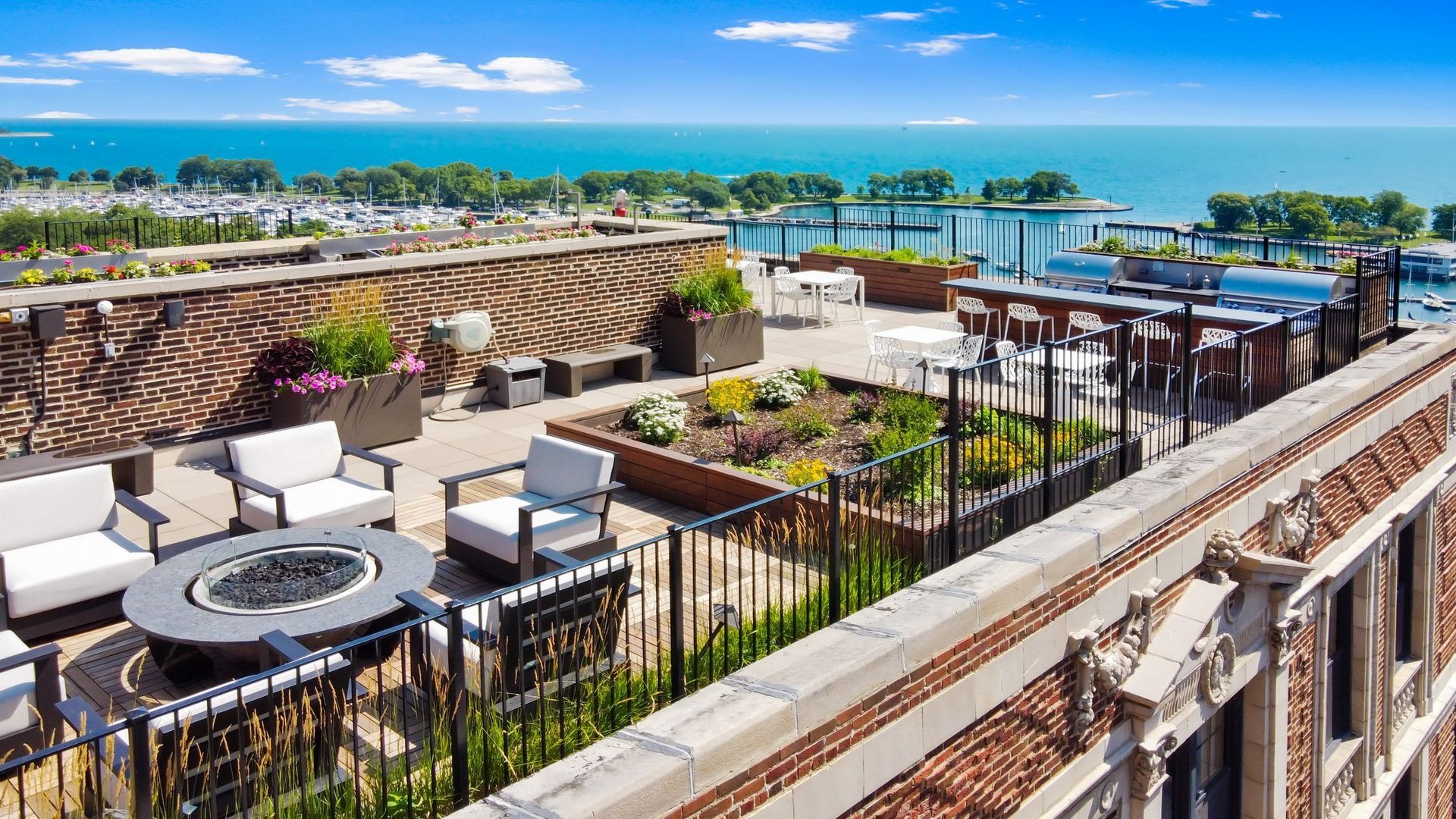 a rooftop terrace with a view of the ocean and a pool