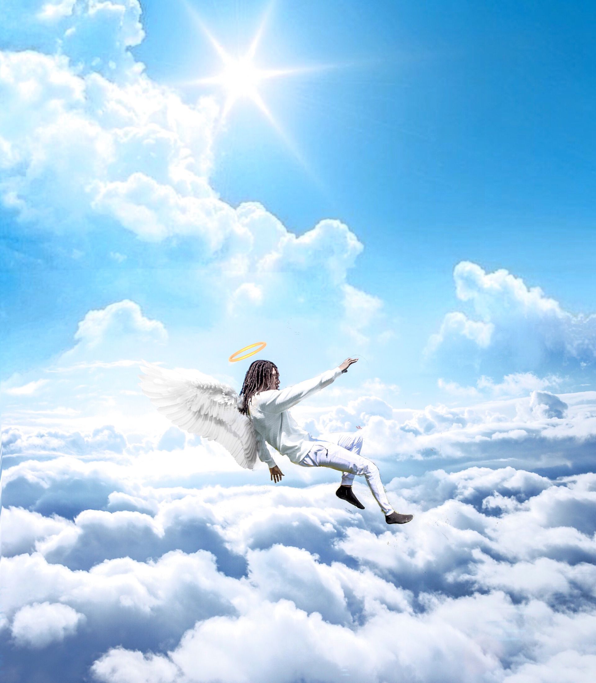 Person in white floating over clouds toward a bright sun in a blue sky