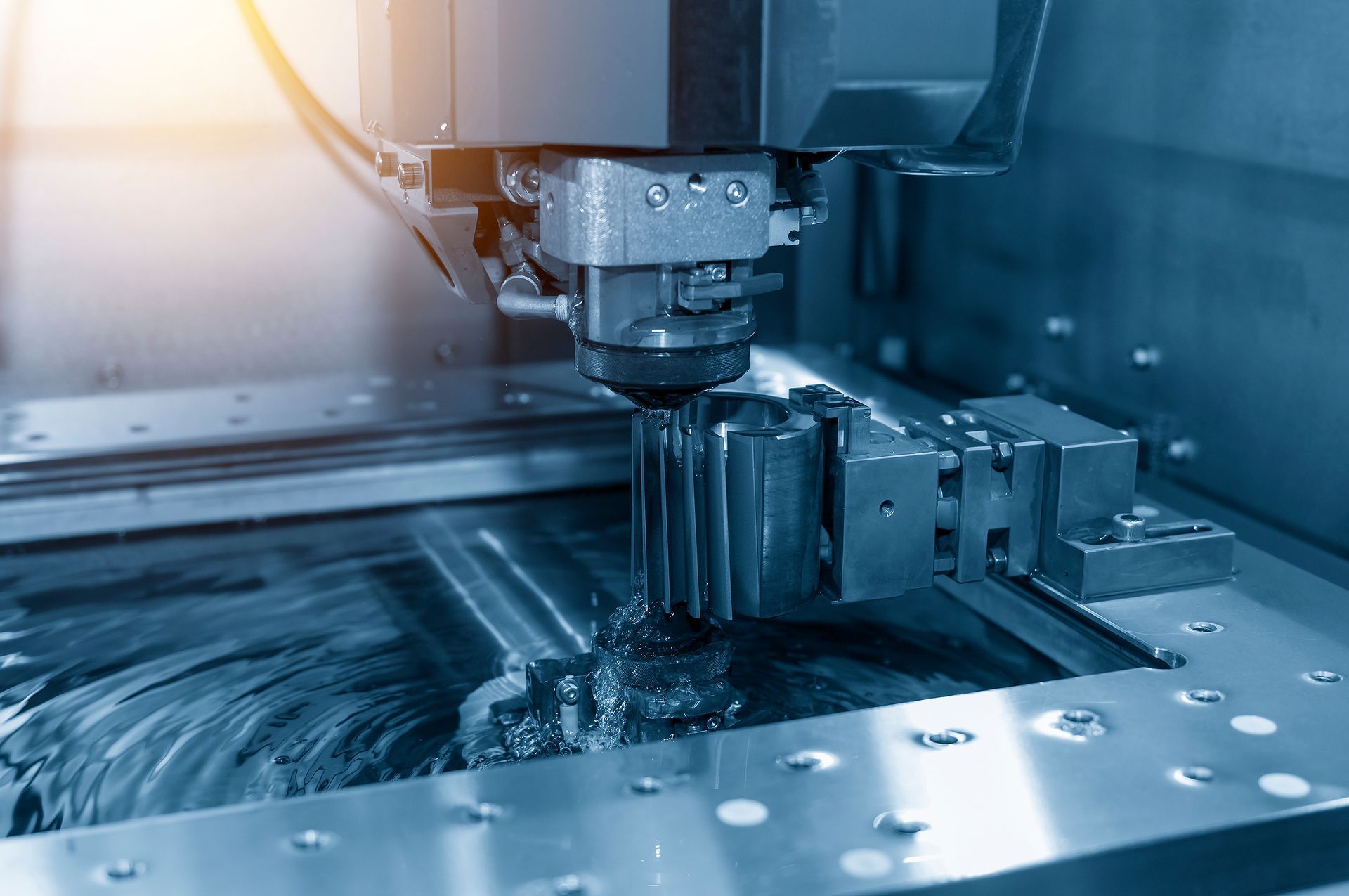 A machine is cutting a piece of metal in a factory.