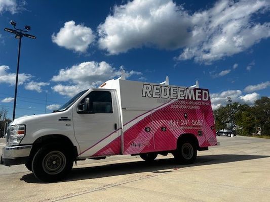 A white truck with the word redeemed on it