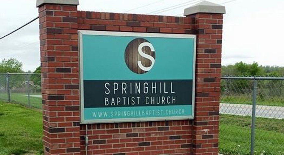 A Sign for Springhill Baptist Church is on a Brick Wall