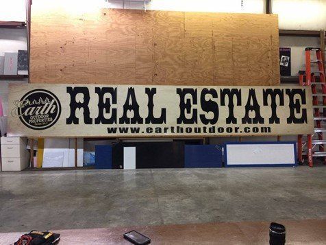 A sign that says real estate on it