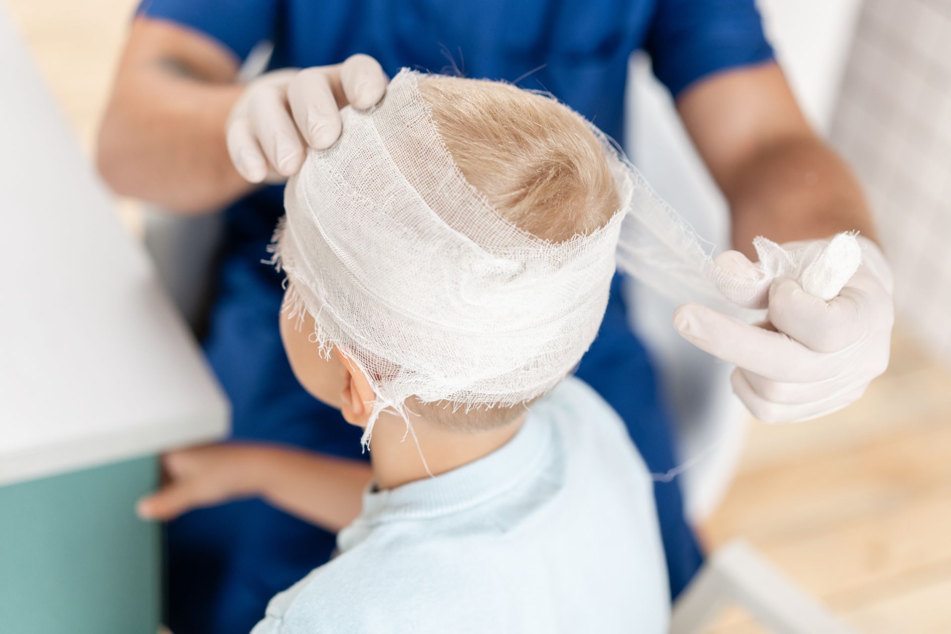 Nurse bandaging a patient’s head in a clinical setting