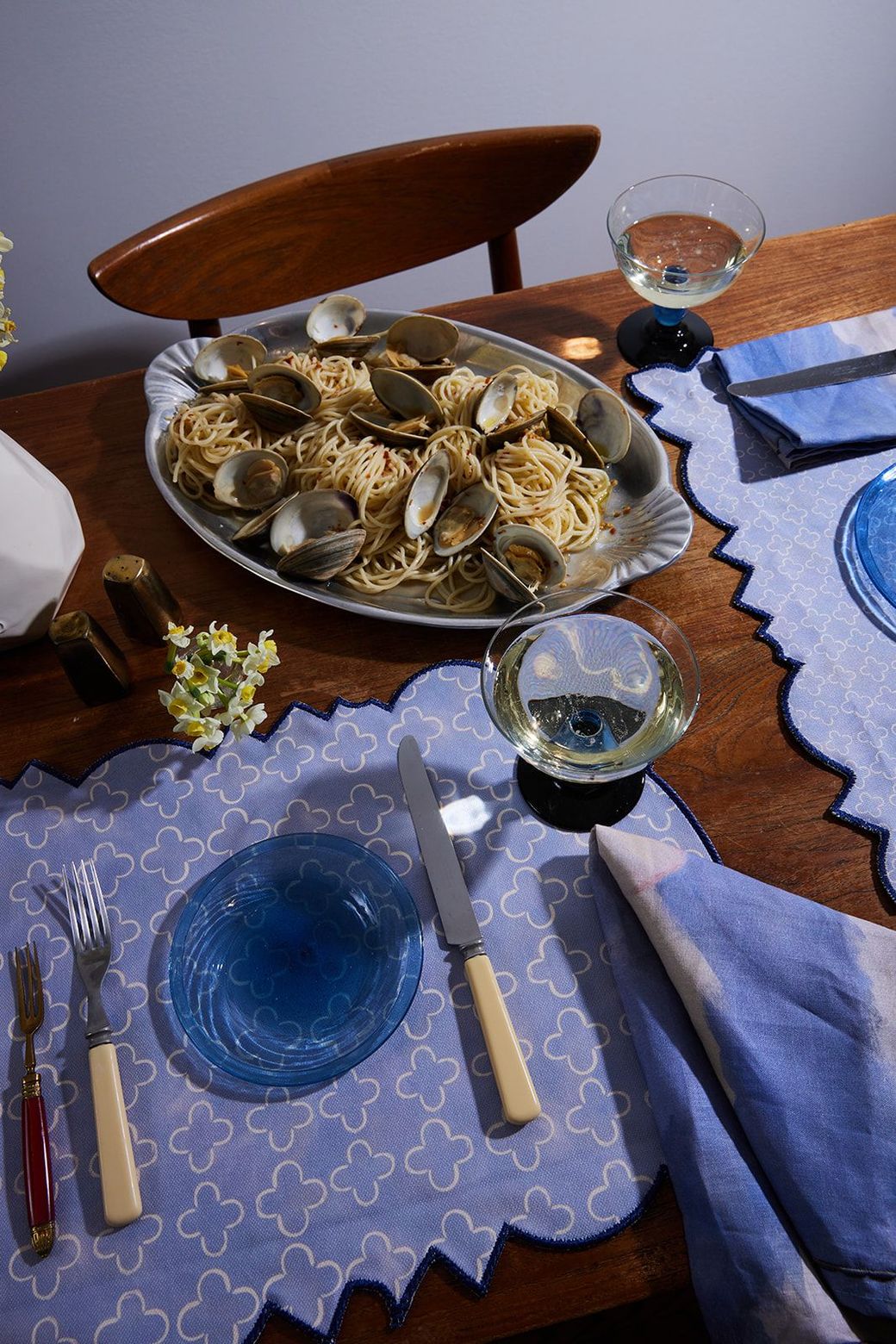There is a plate of spaghetti and clams on the table.