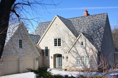 Street view of a grand steep-sloped slate tile roof installed by Kreiling Roofing Street view of a grand steep-sloped slate tile roof installed by Kreiling Roofing