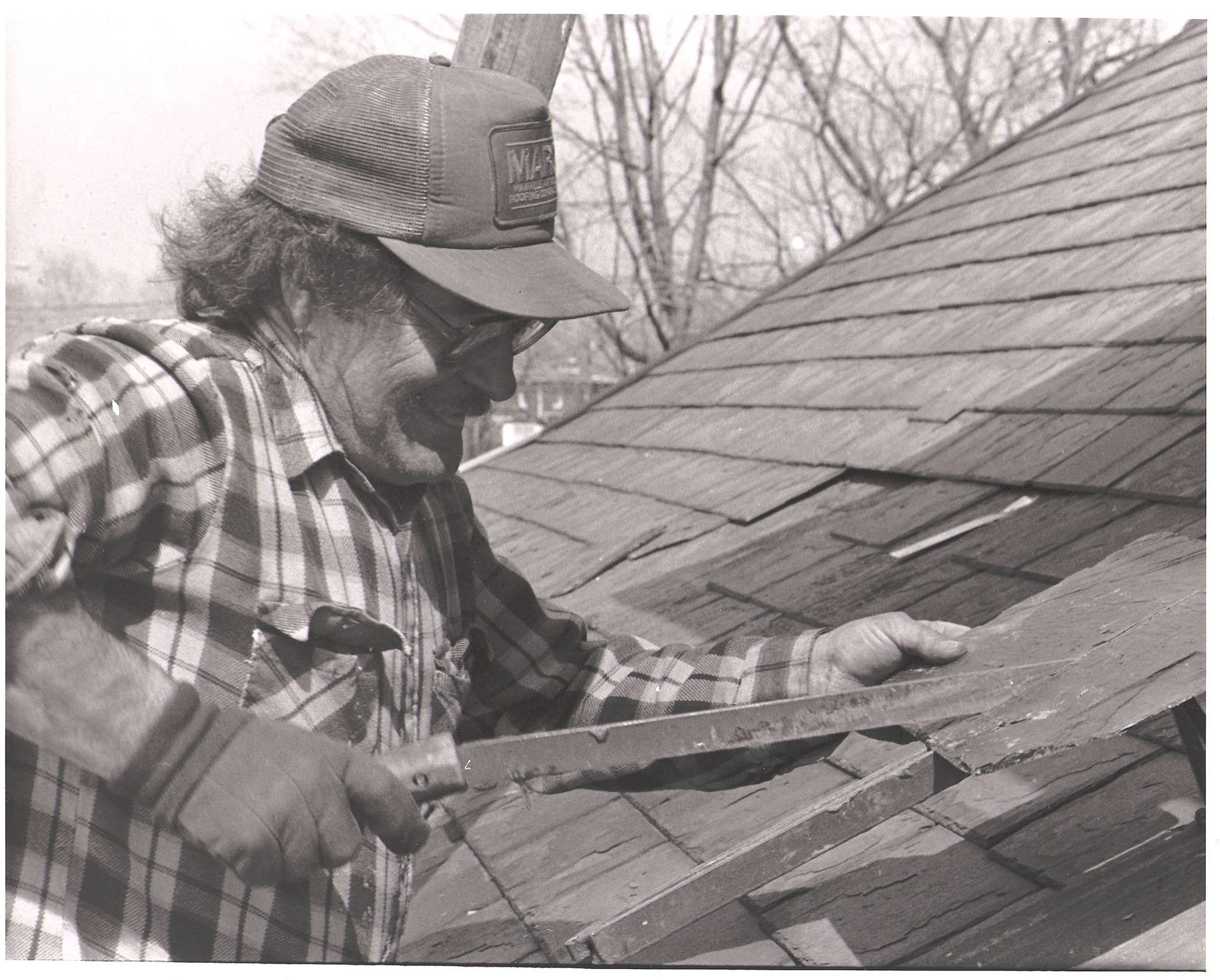 Expert Skylight Installation on EPDM Roof | Commercial Roofing Solutions Kreiling Employee cutting slate