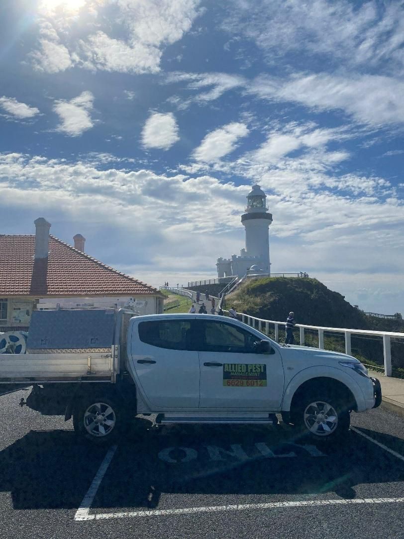 A White Truck is Parked in a Parking Lot in Front of a Lighthouse — Allied Pest Management Northern Rivers in Tweed Heads, NSW