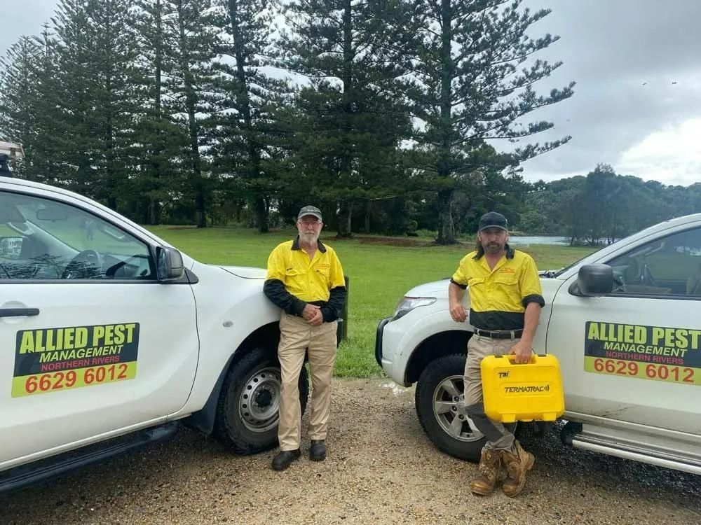 Two Men Are Standing Next to Each Other — Allied Pest Management Northern Rivers in Byron Bay, NSW