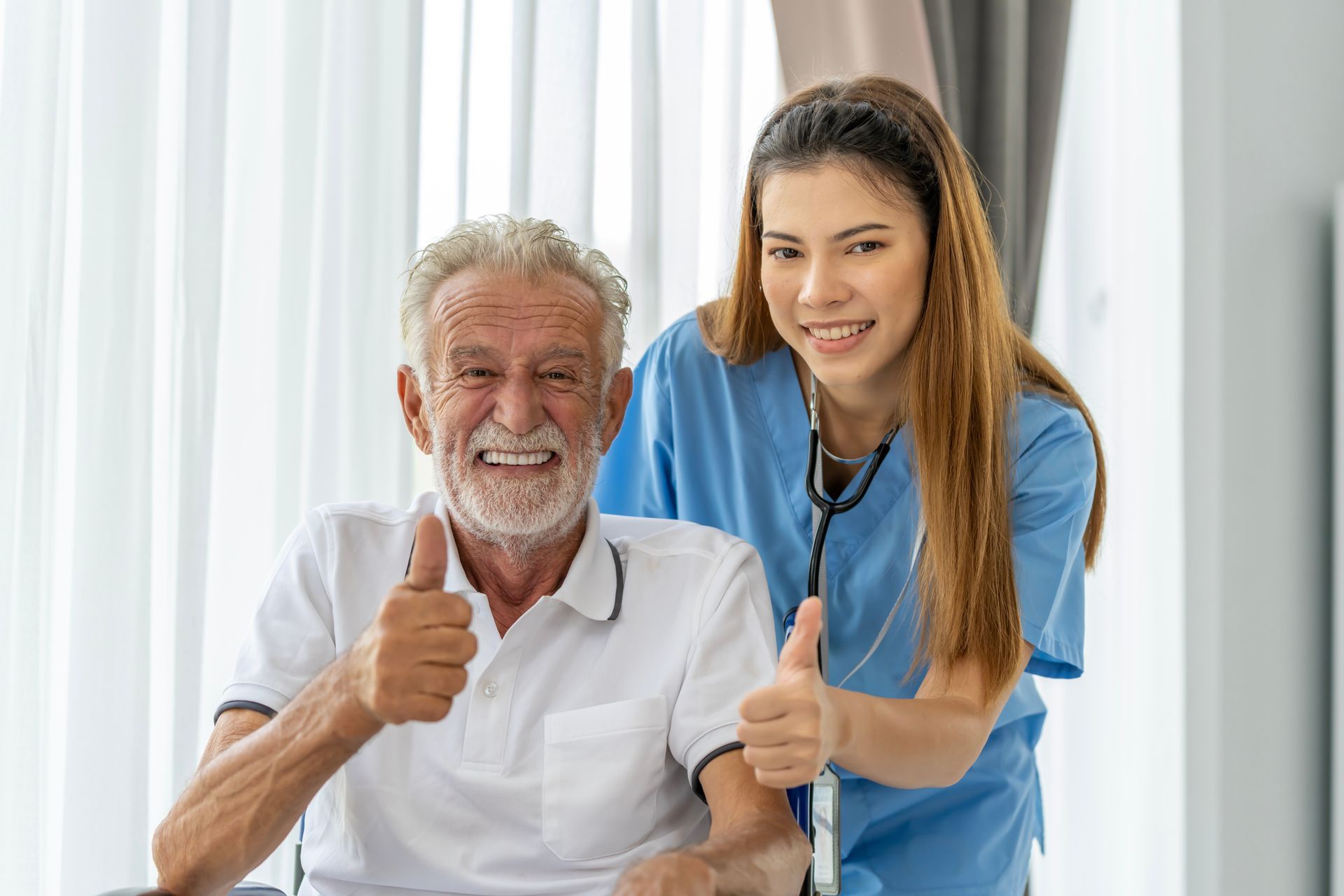 Smiling patient and nurse giving thumbs up in a bright clinic room
