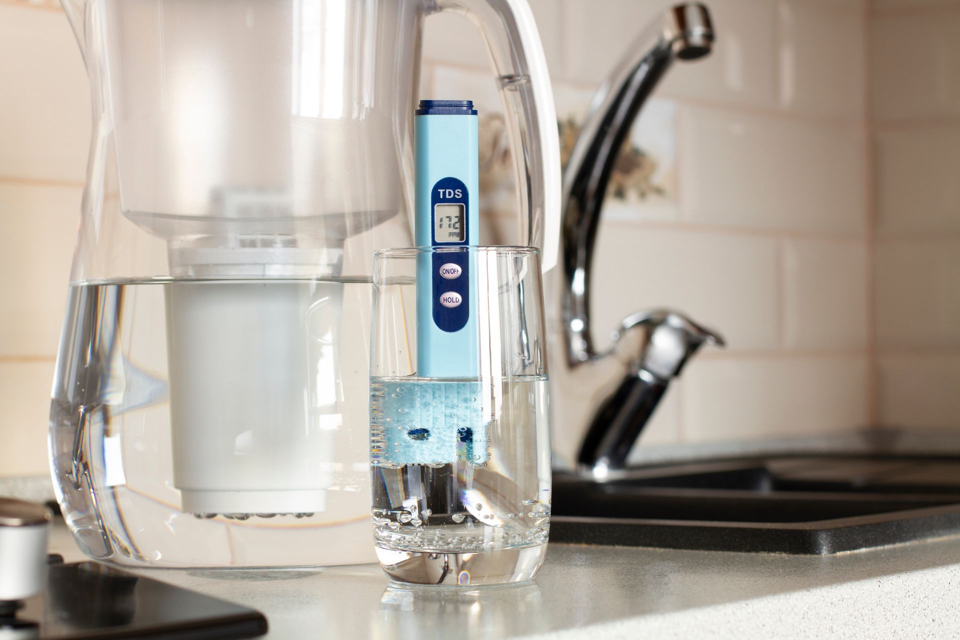 TDS meter testing water quality, measuring need for residential water softening equipment