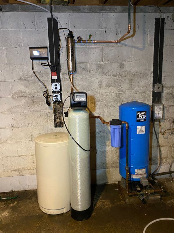 Water treatment system in a basement. Includes a softener, filtration, and pressure tank.