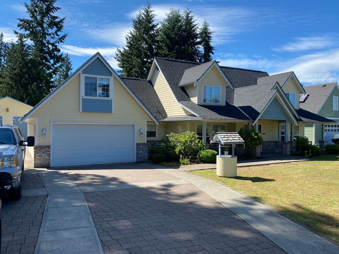 A large house with a white truck parked in front of it
