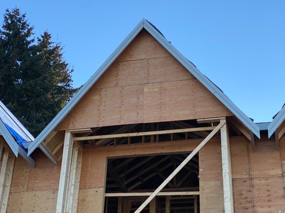 A house under construction with a blue sky in the background