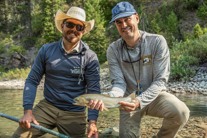 two men holding antlers of elk they have downed