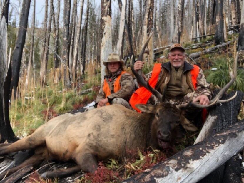 Man holding antlers of elk
